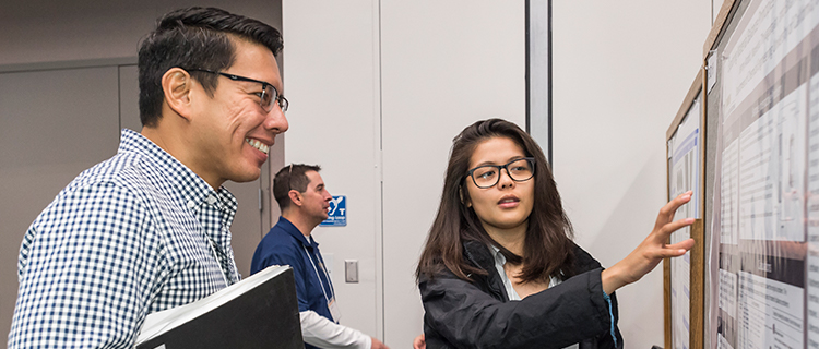  Scholars engage with faculty judges and fellow scholars as they present their research at the 2018 UC LEADS Symposium at UCSB